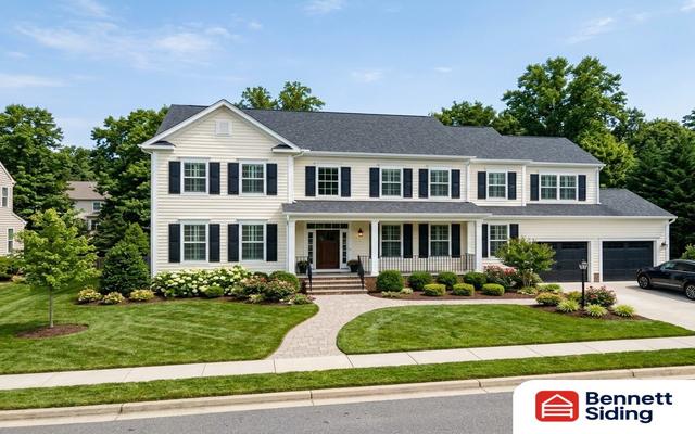 Two-story house with manicured lawn, shrubs, and a parked car in driveway – siding gallery, Arden, NC