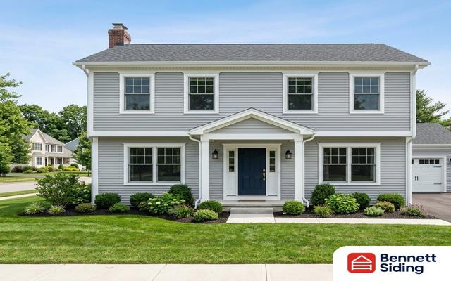 Two-story gray house with white trim, blue door, and landscaped yard – siding gallery, Angier, NC